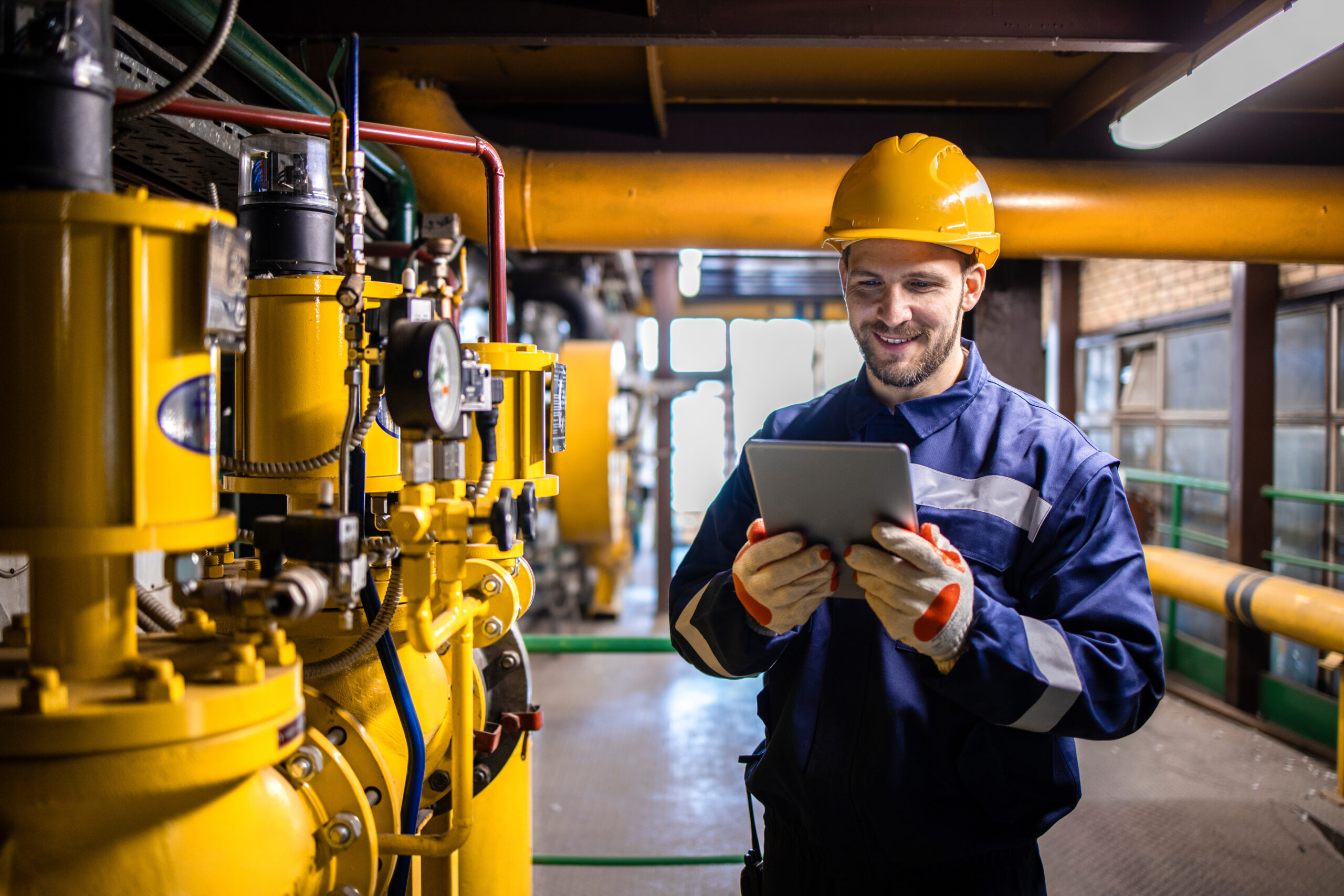 Professional industry worker checking production results of natural gas in refinery plant.