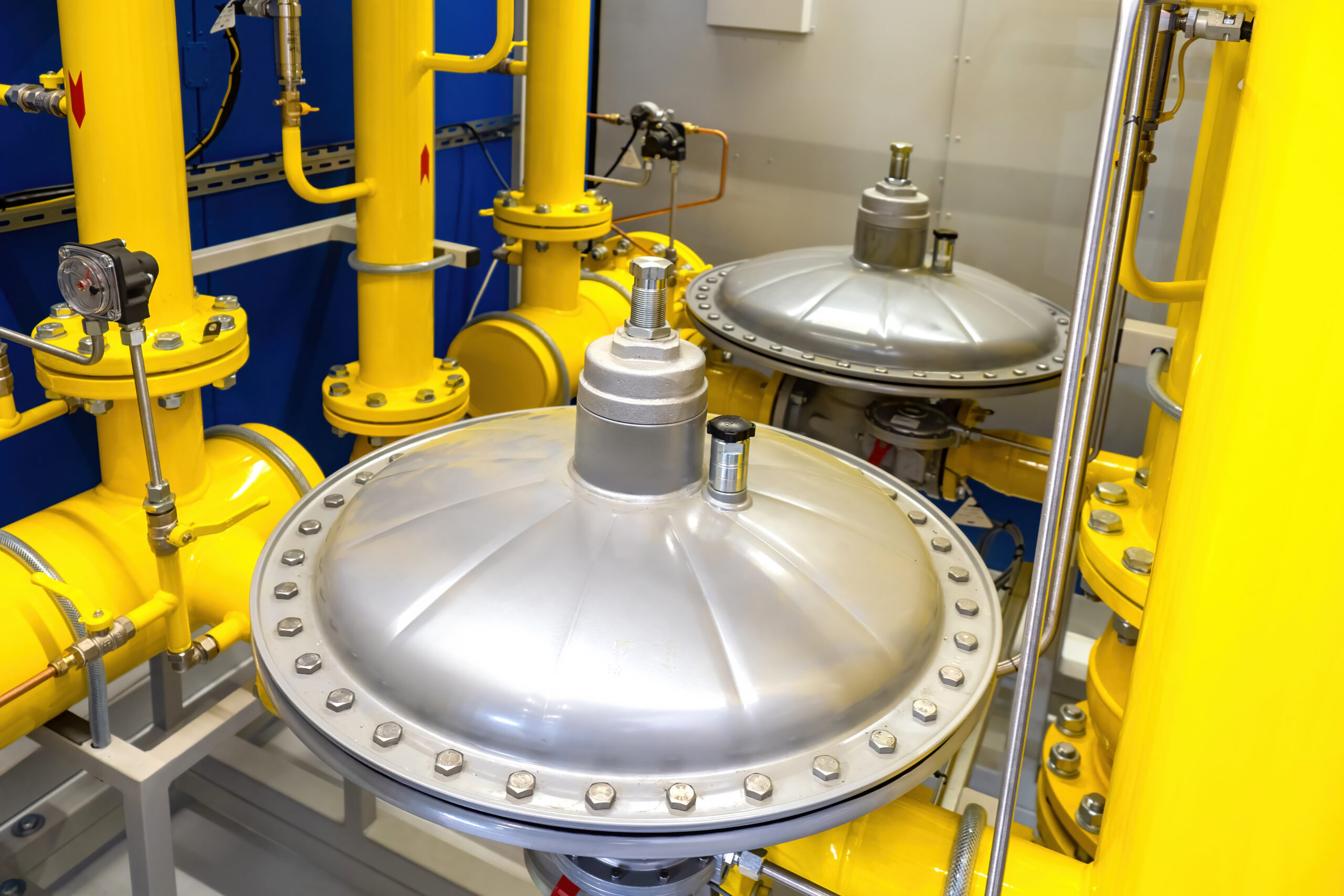Gas equipment. Yellow pipes in production room pressure reducers on gas pipes. Equipment for supply of propane to enterprises. Pressure regulators for boiler equipment. Gas technologies